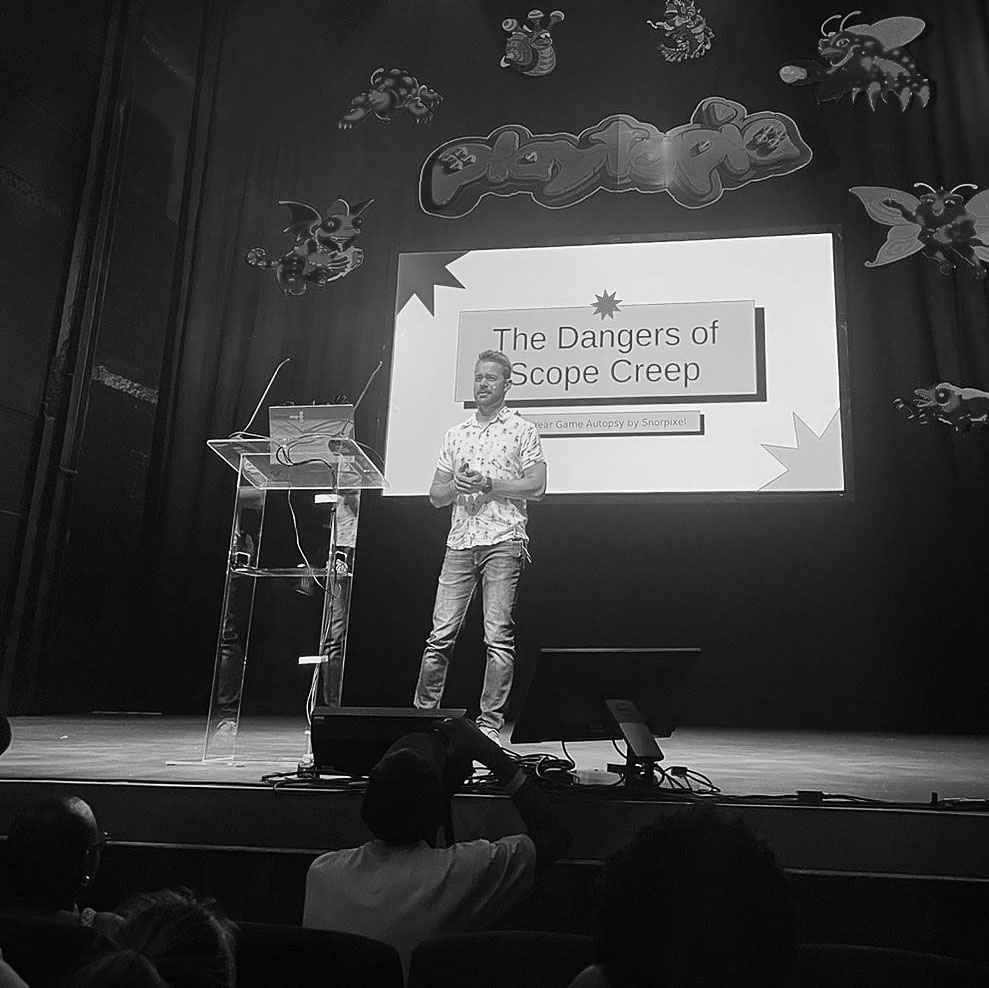 SP van der Merwe presenting The Dangers of Scope Creep on stage at Playtopia Festival
